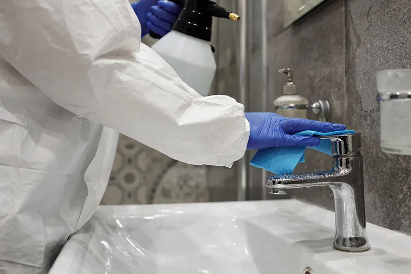 professional-biohazard-cleanup-islip A woman doing professional biohazard cleanup in a bathroom in Islip
